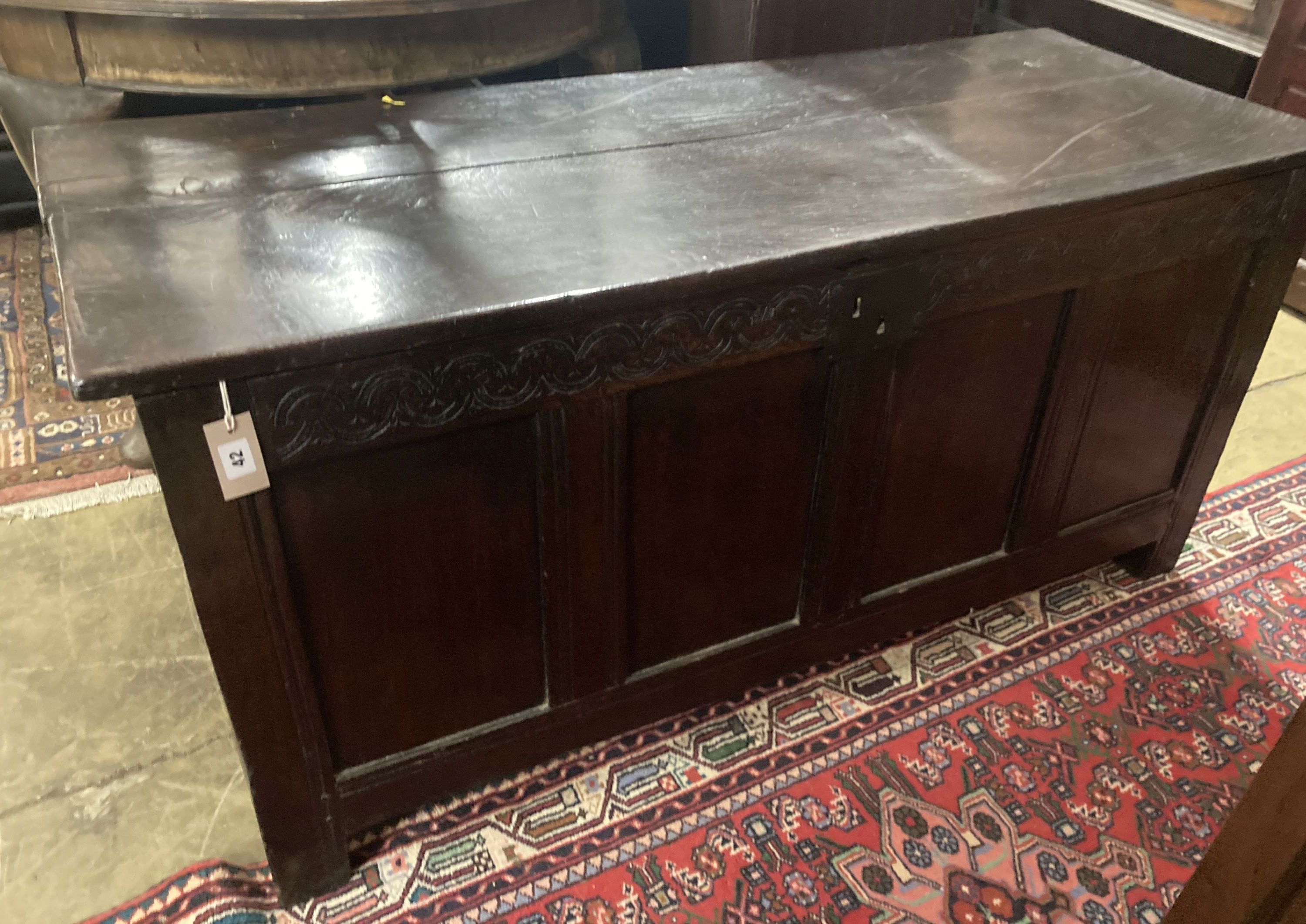 An 18th century panelled oak coffer, length 140cm, depth 54cm, height 67cm